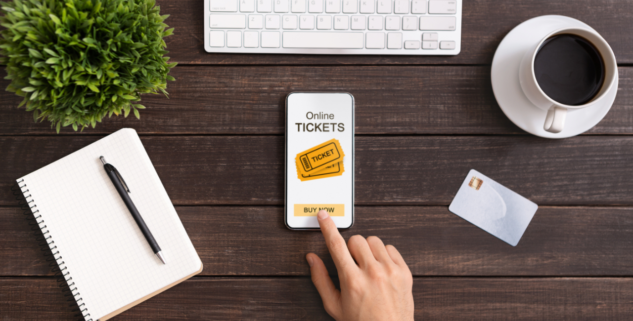 Photo of desktop with mobile showing online ticket booking