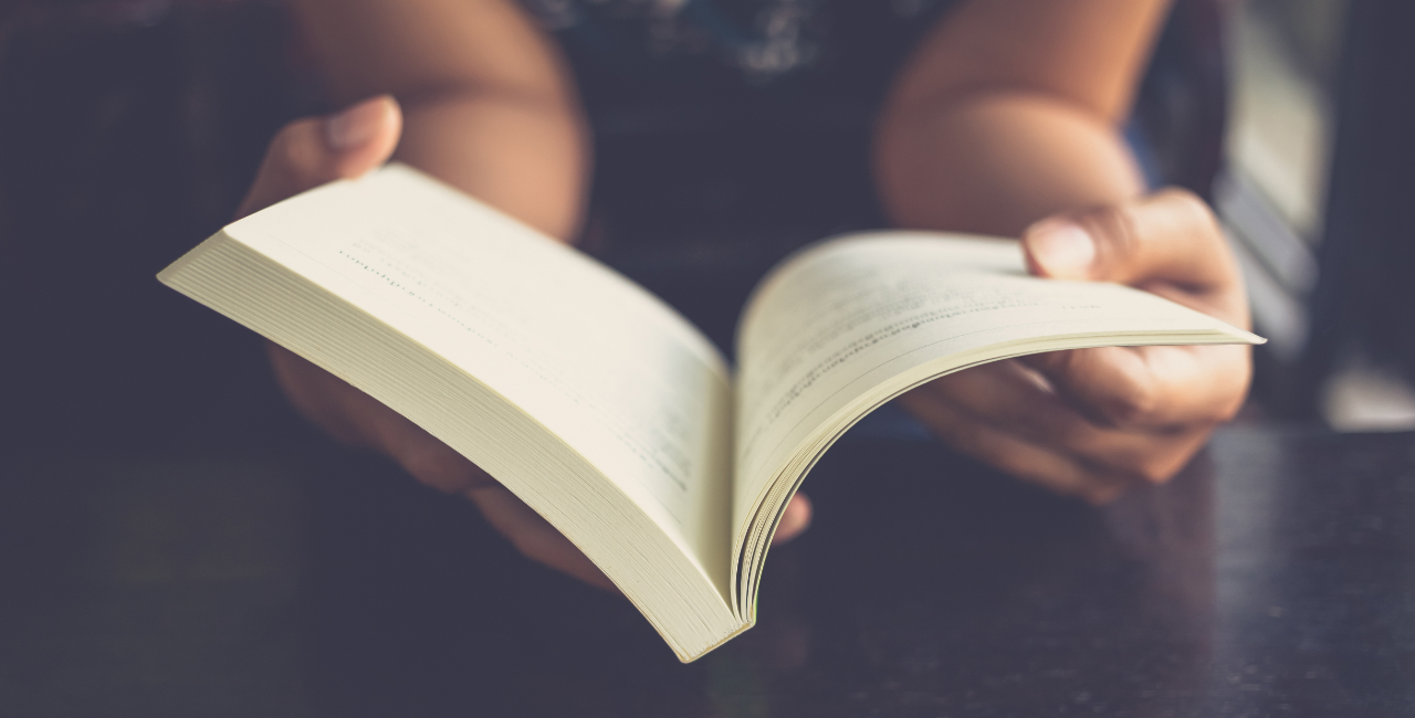 Photo of someone holding a book open